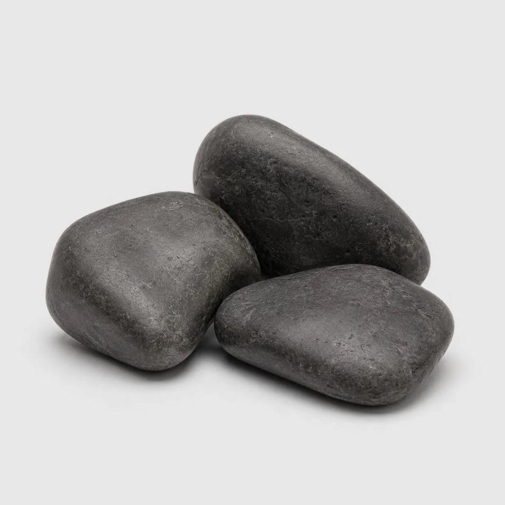 Three smooth black polished decorative stones arranged in a small pile on a light gray background.