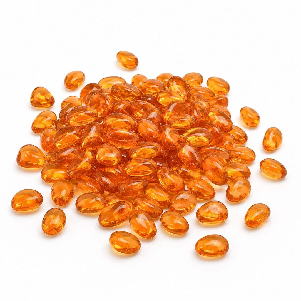 Pile of smooth, translucent orange glass pebbles on a white background.