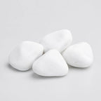 A pile of smooth, rounded white decorative stones in medium size on a plain light gray background.
